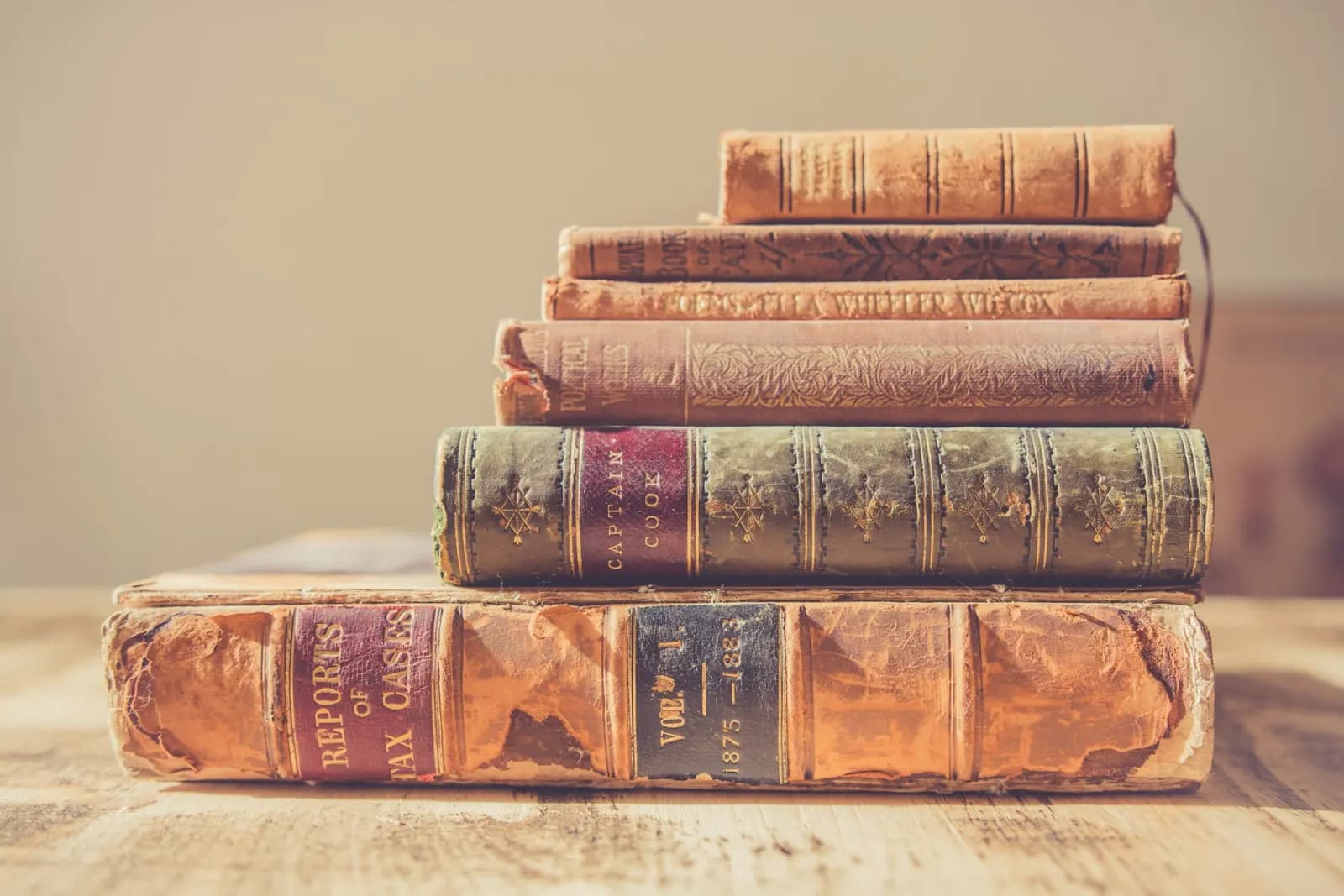 A stack of open old books piled on top of each other.