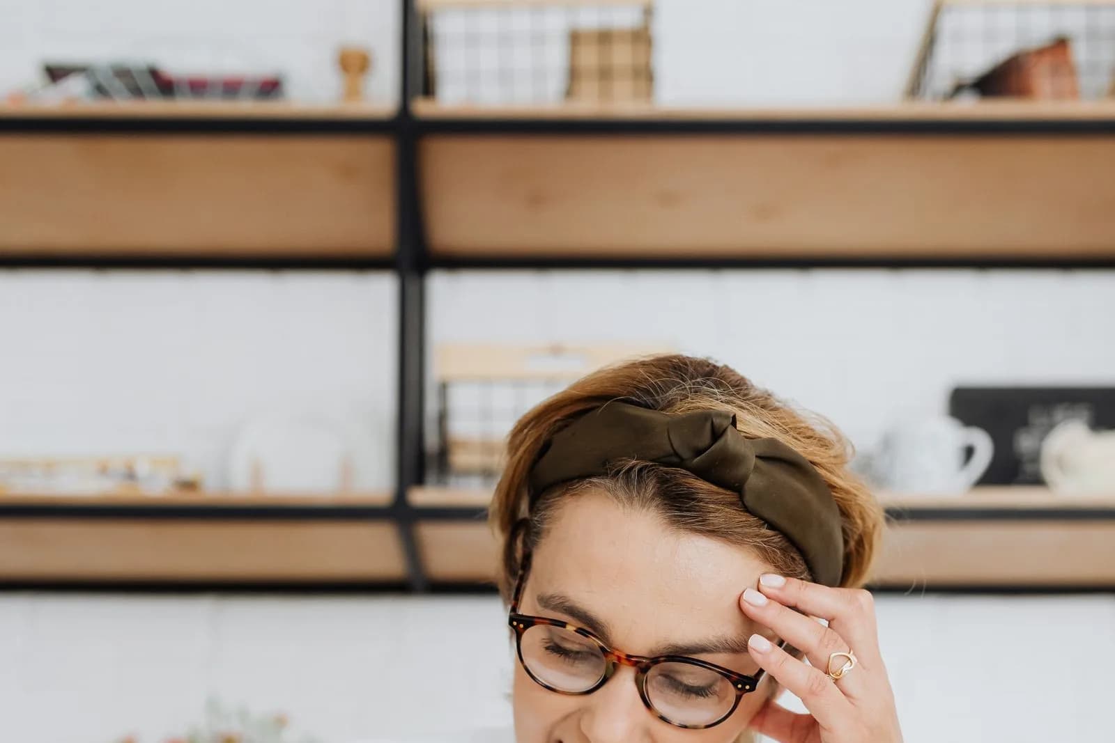 A pensive, frustrated woman facing an open book, symbolizing the reading plateau in language learning.