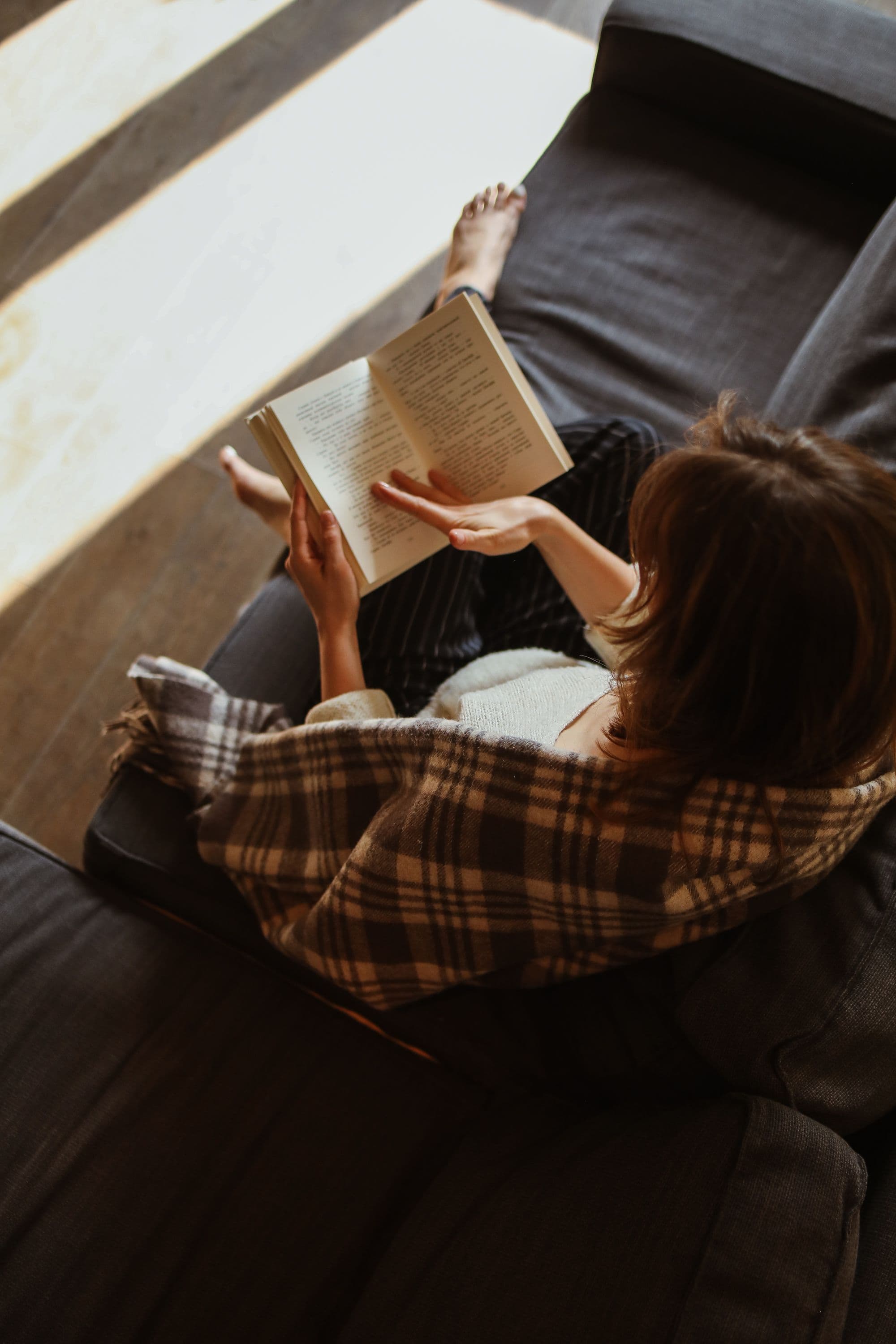 Person reading calmly with a cup of coffee nearby